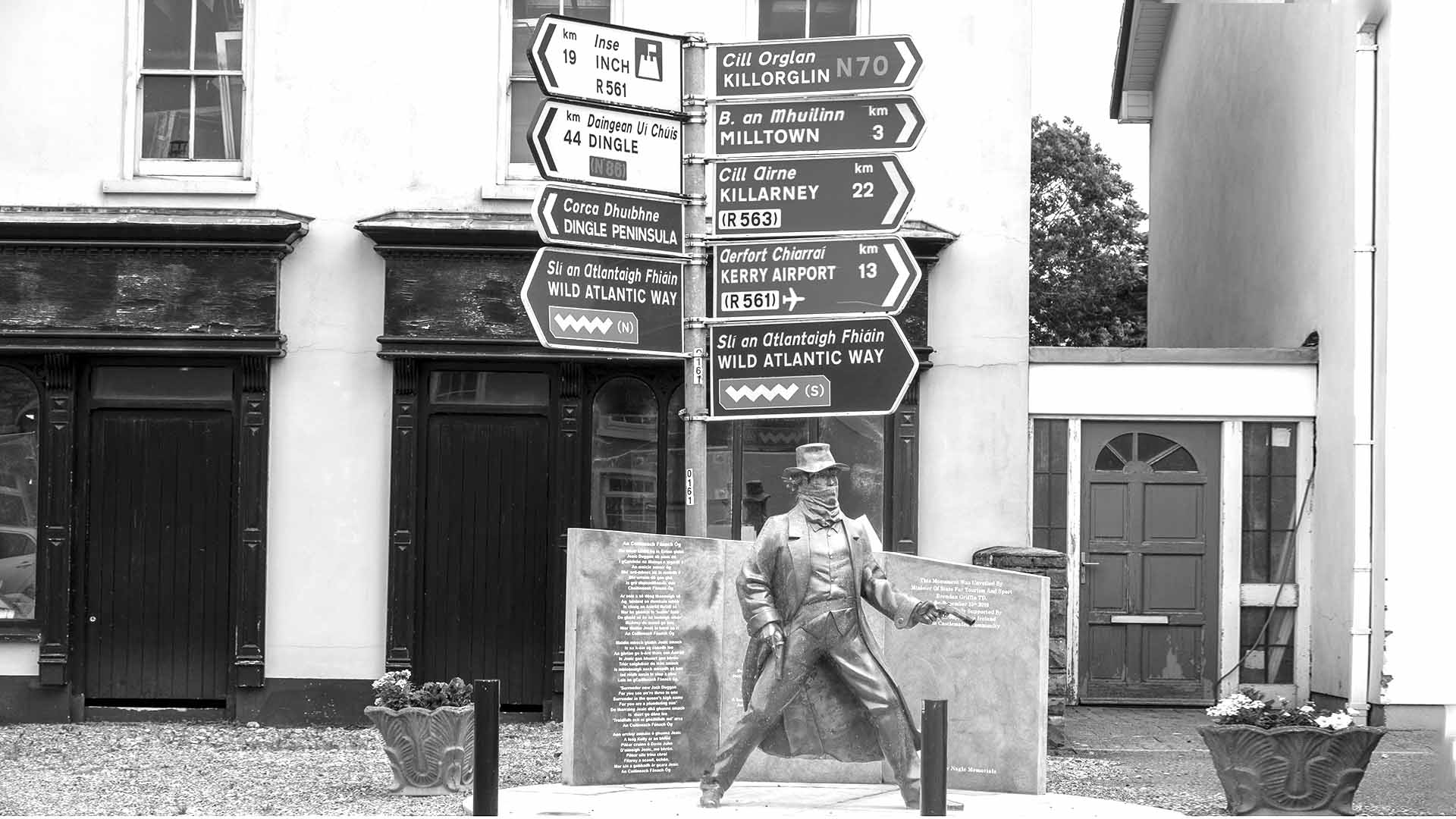 a statue of a man with a gun and signs