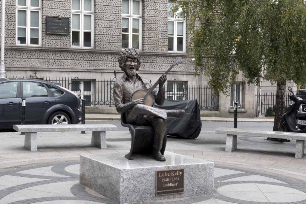 Statue of Luke Kelly playing a musical instrument