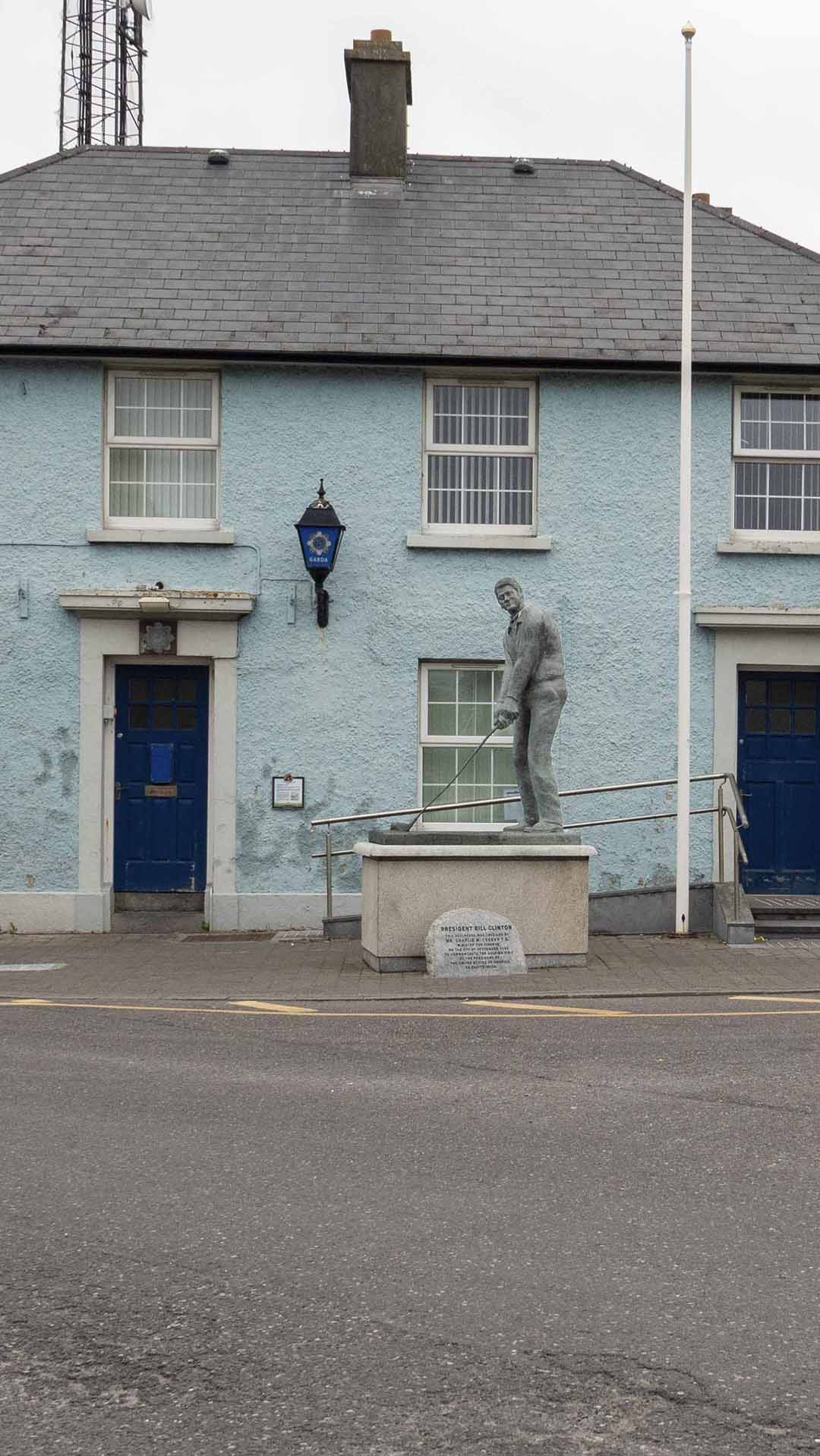 a statue Bill Clinton holding a golf club