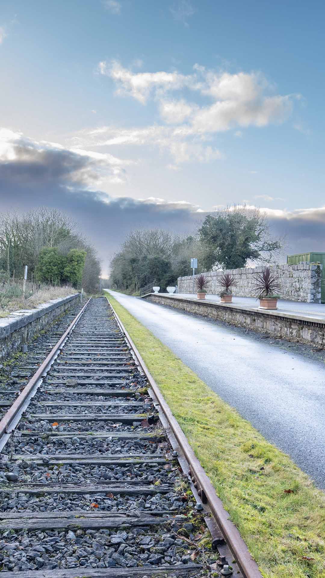 a train tracks next to a road