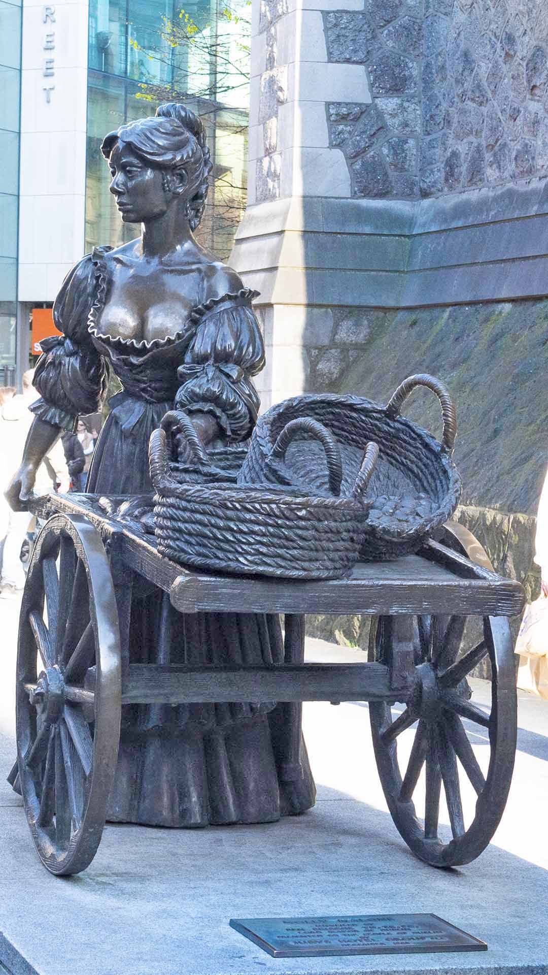 a statue of a woman on a cart