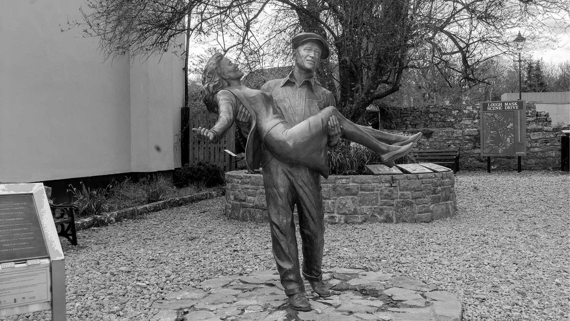 a statue of a man carrying a woman