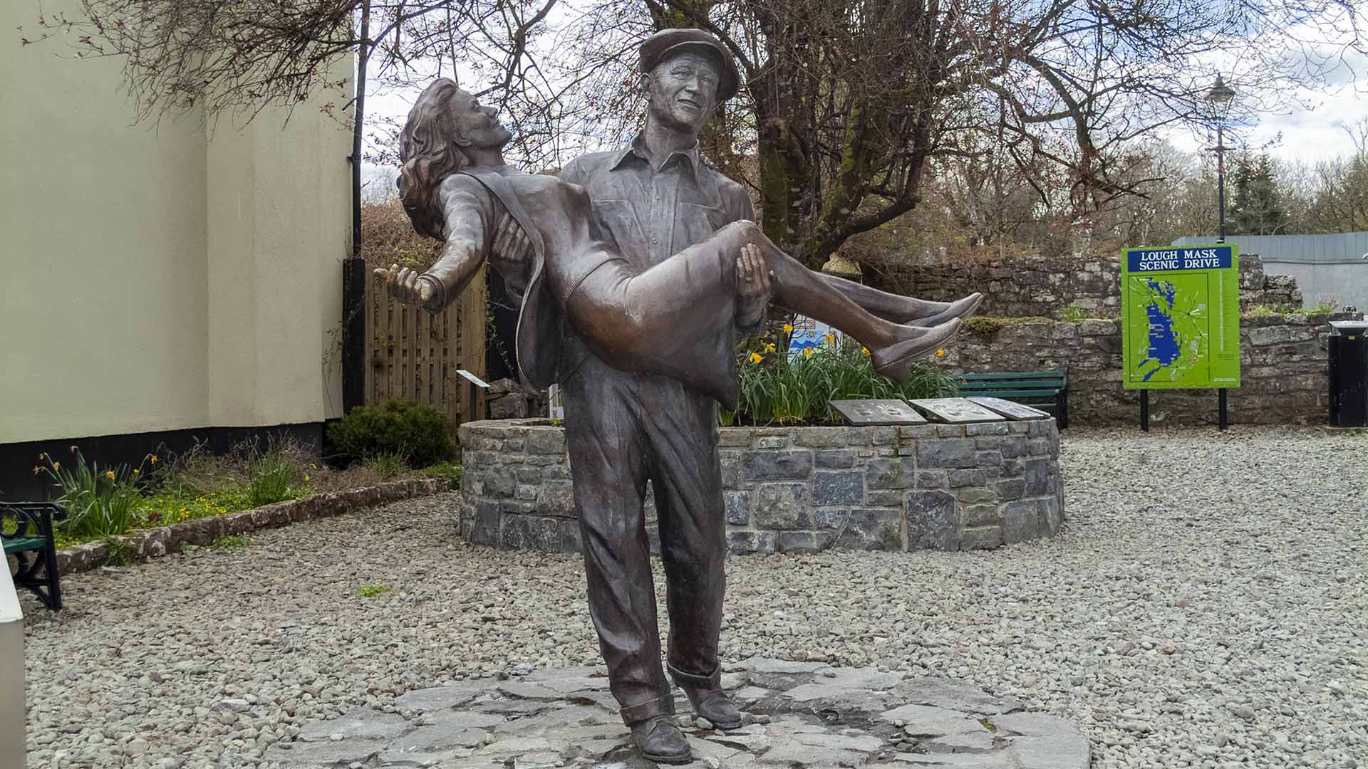 a statue of a man carrying a woman