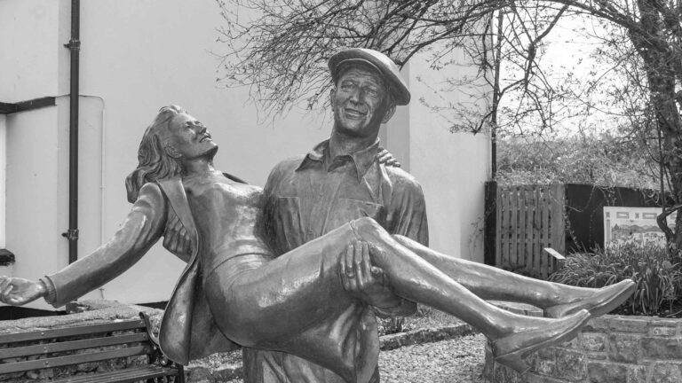 a statue of a man carrying a woman