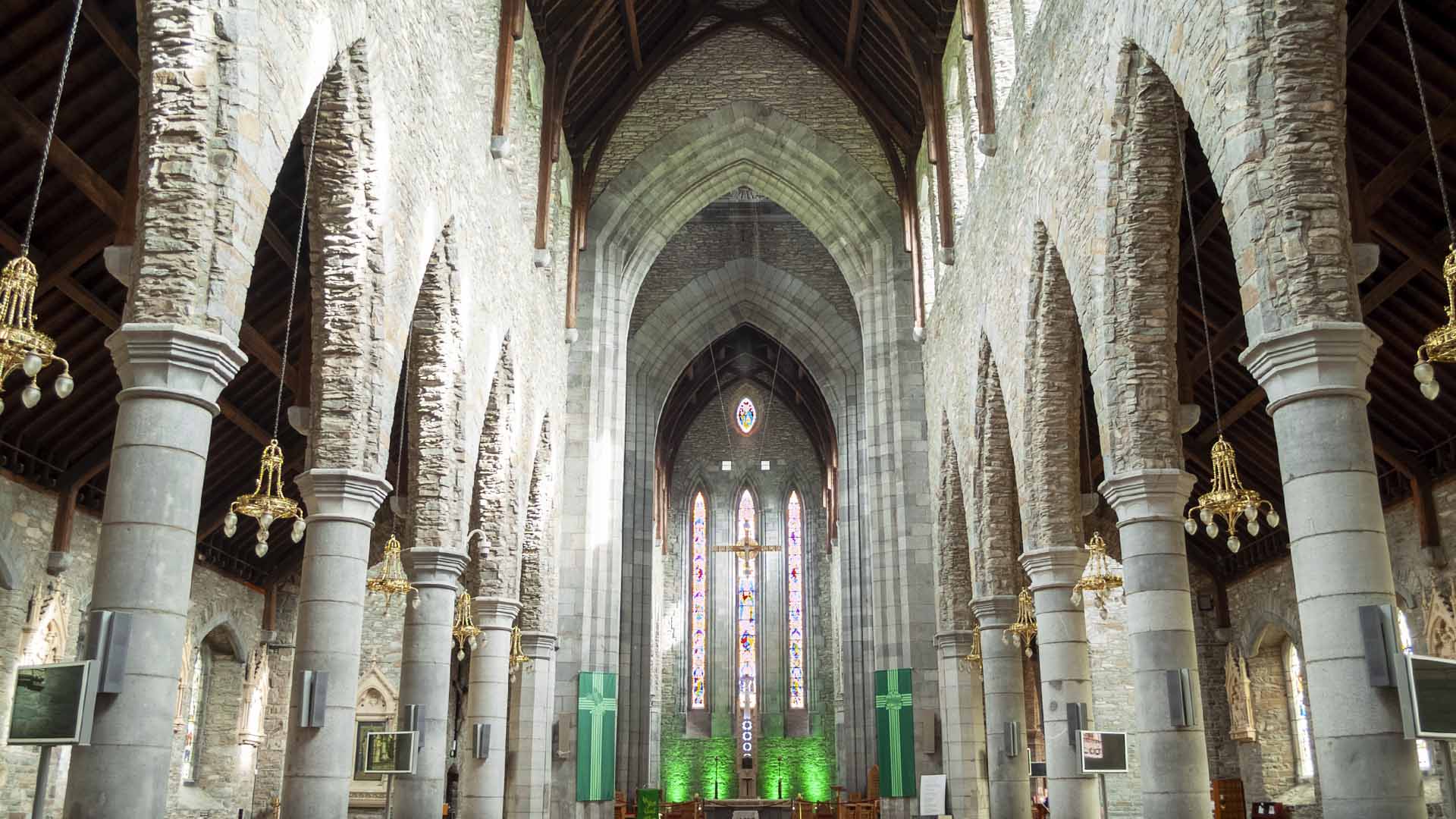 a large stone building with a cross in it