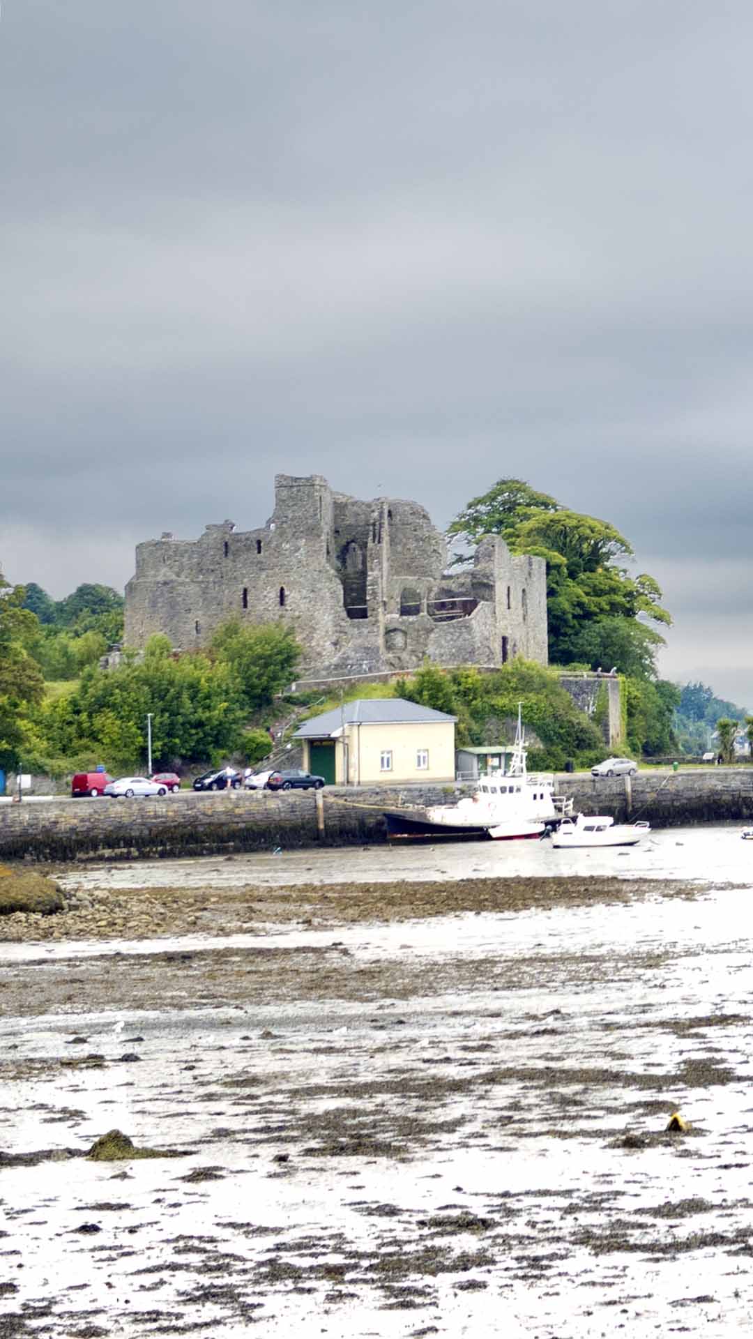 a stone castle with boats in the water