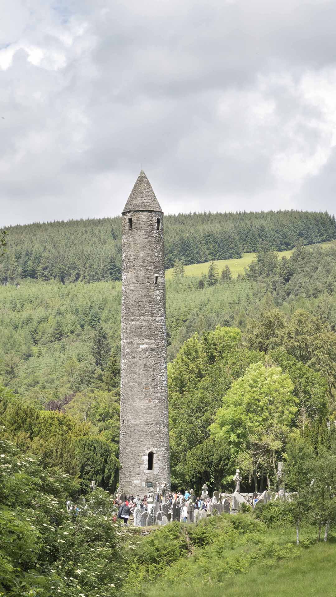 a tall stone tower in a forest