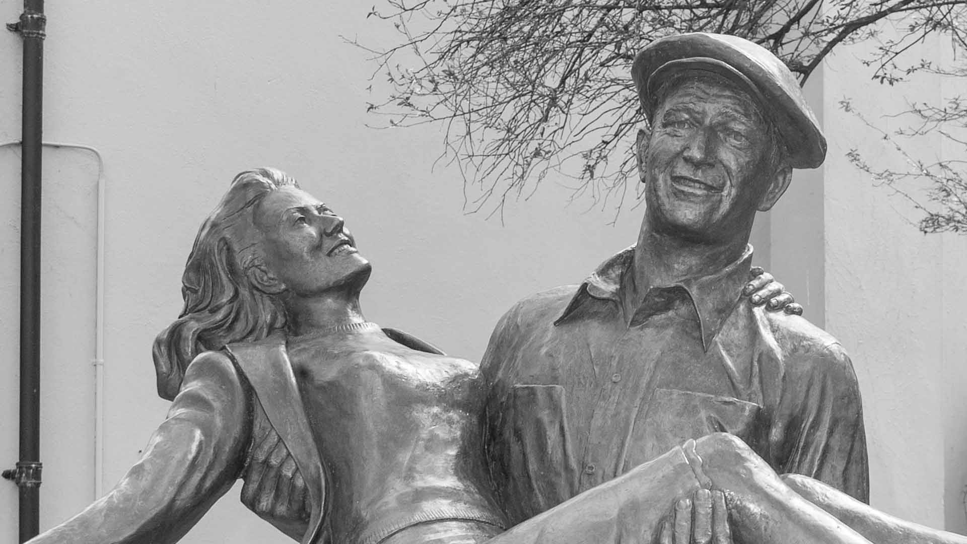 a statue of a man holding a woman